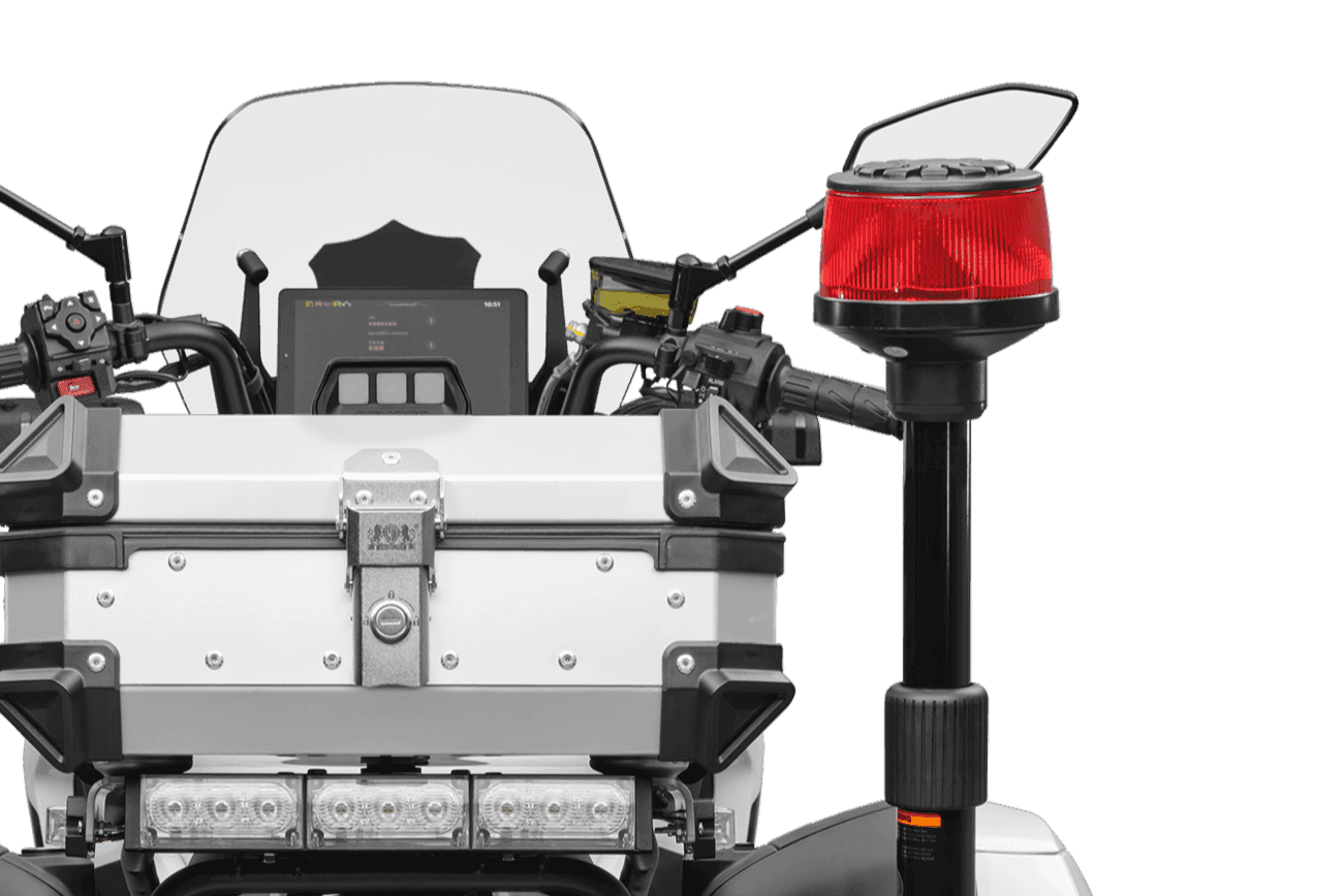 Top-down side view of a white police motorcycle's rear, featuring a red warning light.